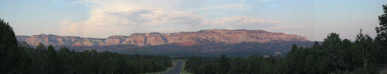 The sun sets over US9 snaking out of Zion National Park towards the east